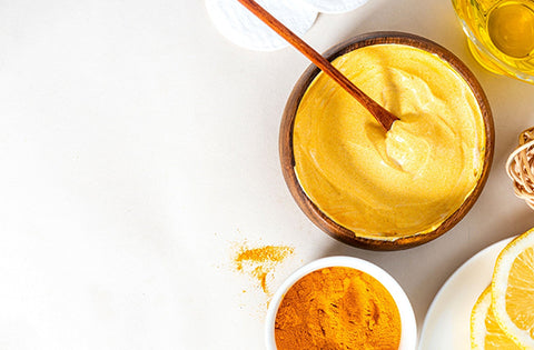 Yoghurt and turmeric face pack in a bowl on table