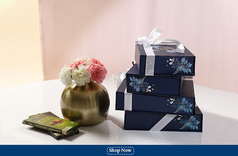 Blue Nectar diwali gift boxes with chocolates on table