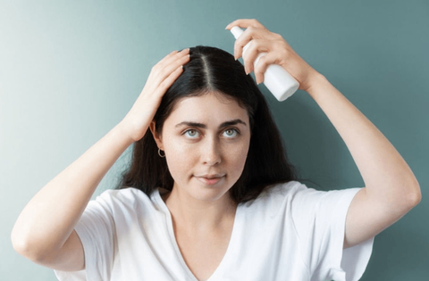 Girl is applying hair serum 