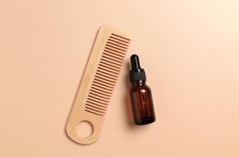 comb and hair oil is on table 