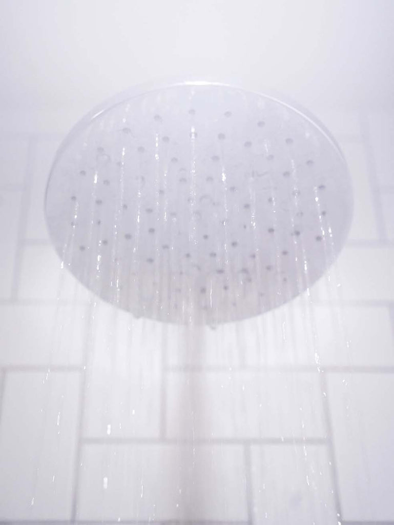 Shower Head Raining water in steamy bathroom