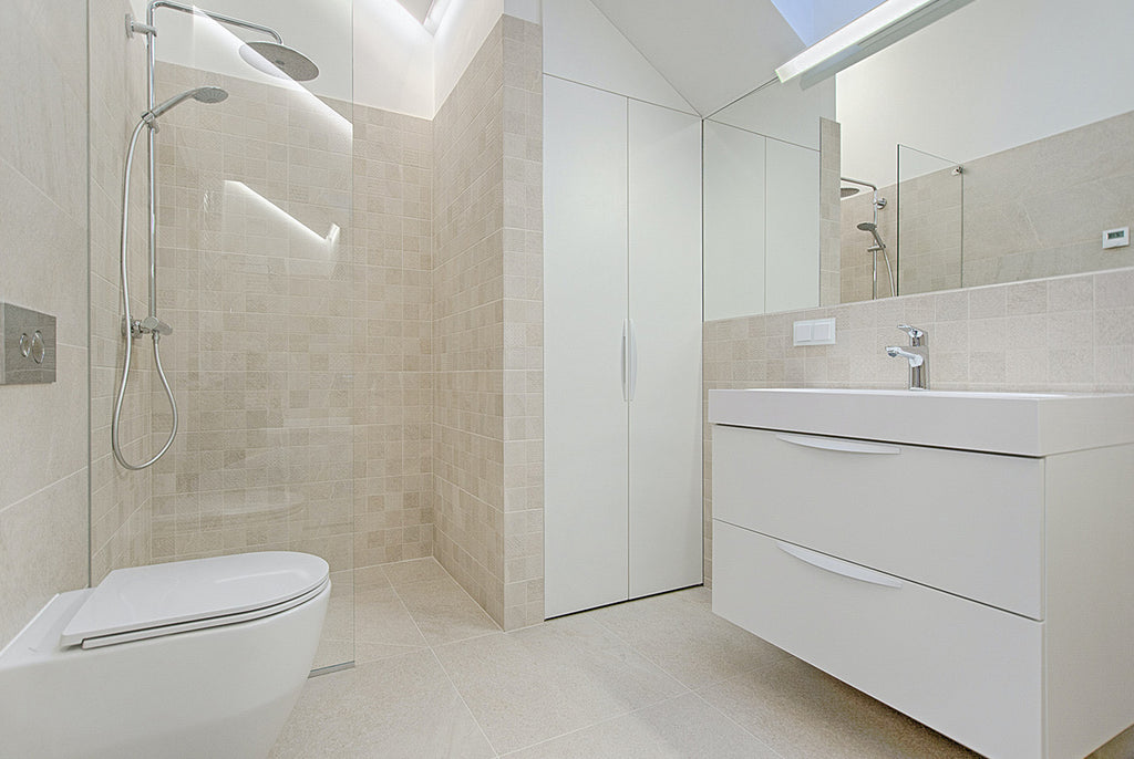 three quarter bathroom with shower, sink, and toilet
