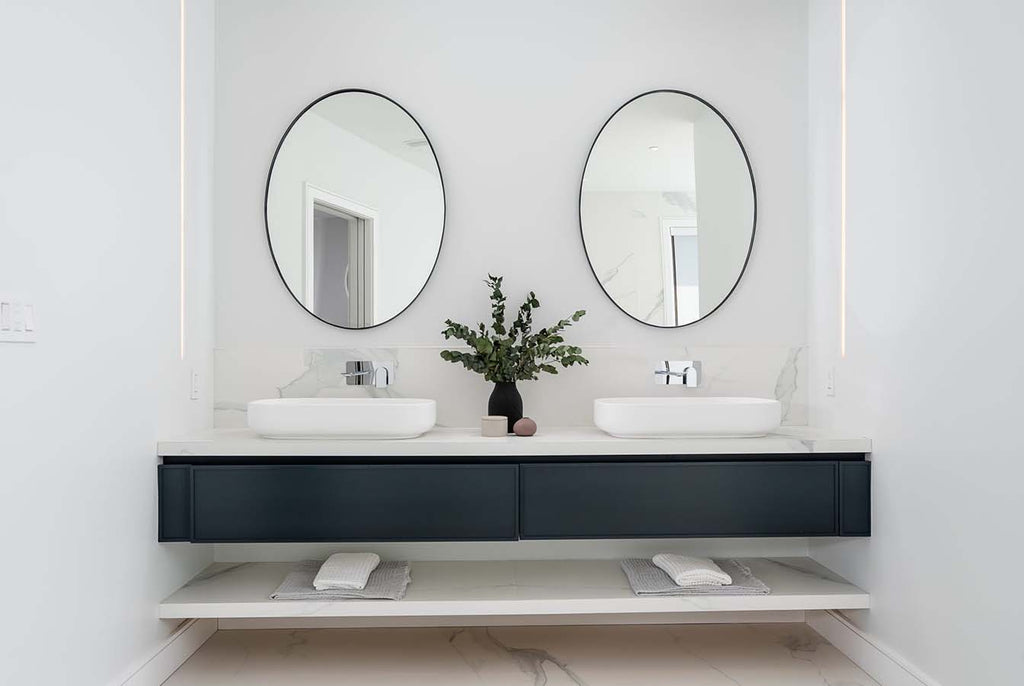 floating double vanity with double black oval mirrors 