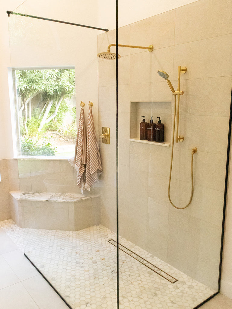 bathroom with golden shower fixtures