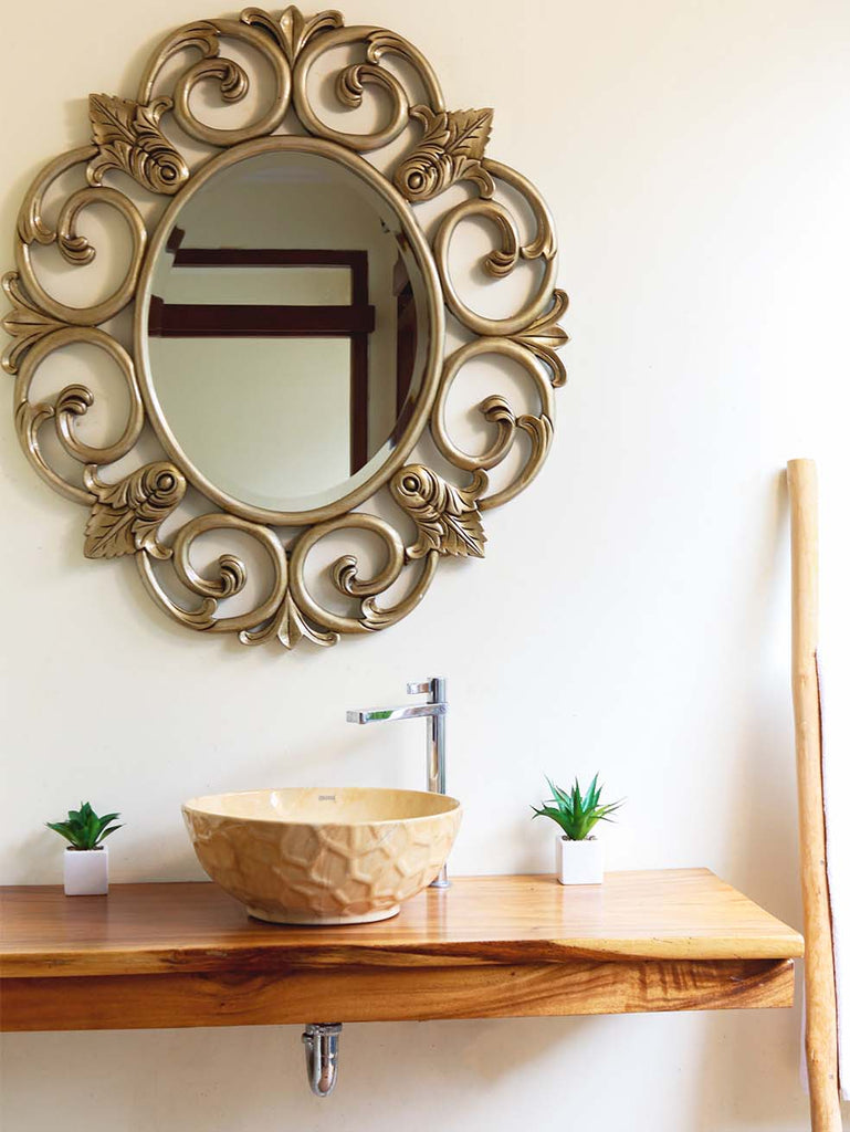 round antique brass mirror over vessel sink