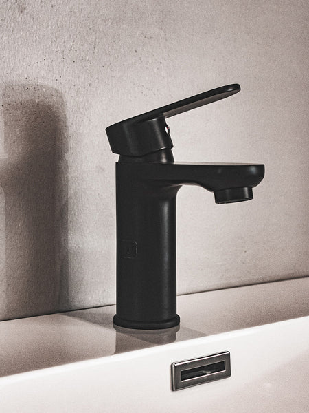 matte black bathroom faucet turned on with no water