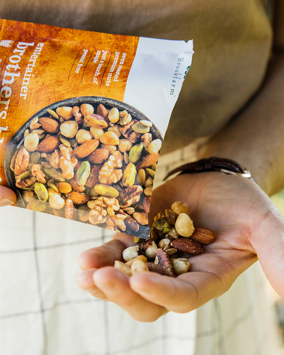 Brothers Blend Premium Nut Mix being poured into left hand to showcase the Australian nut mix