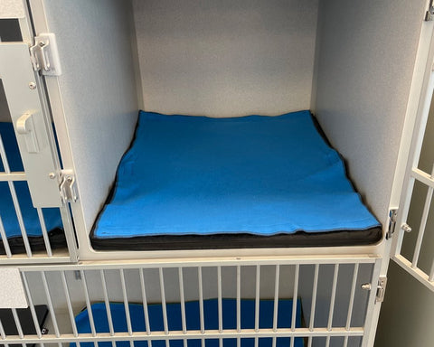 Velcro fastening towels on custom kennel mat for veterinary patients, providing warmth and easy towel replacement