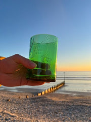 Photo of a Gordon's gin glass set against a beach scene