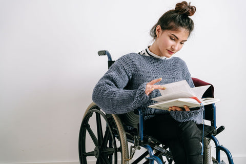 Lady reading book in wheelchair