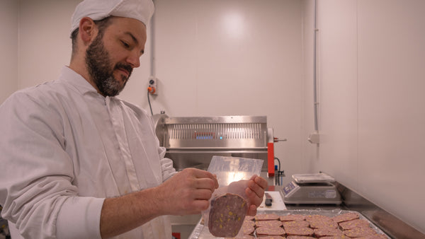 chris budicin, chef at city larder, packaging a slice of terrine