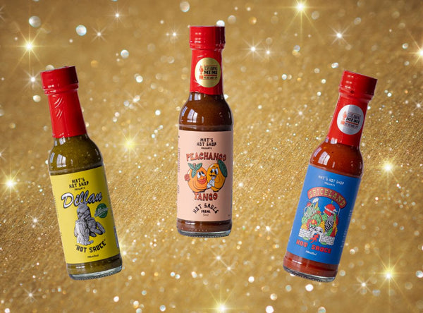 three bottles of hot sauce on gold background