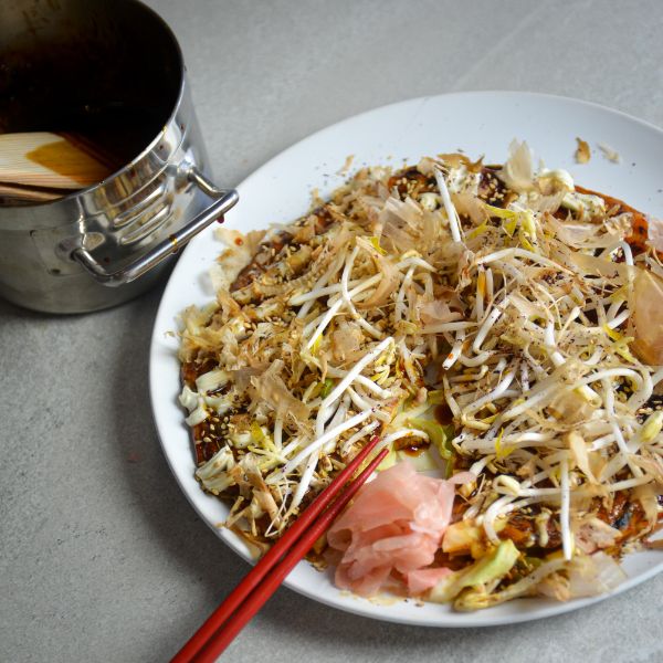 plate with okonomiyaki topped with bonito flakes