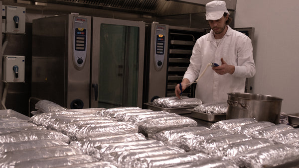 sinclair scott, chef at city larder, temperature checking a terrine (fresh out of the oven)