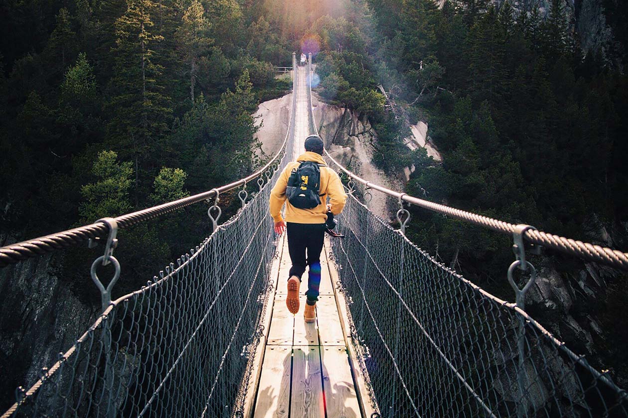 a traveling man running on a bridge