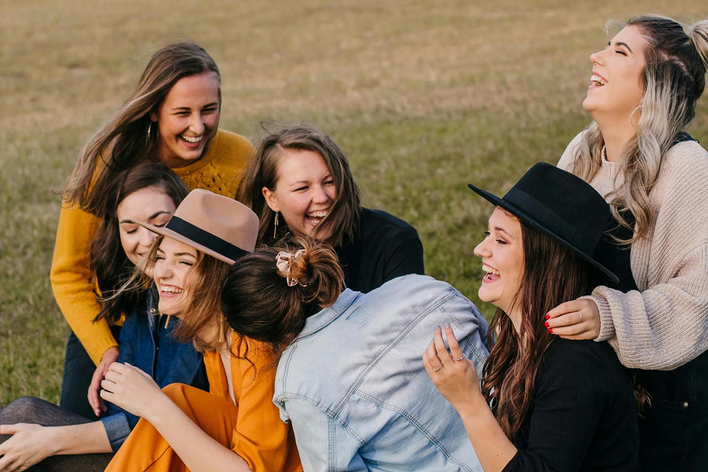 Group of women in a field laughing