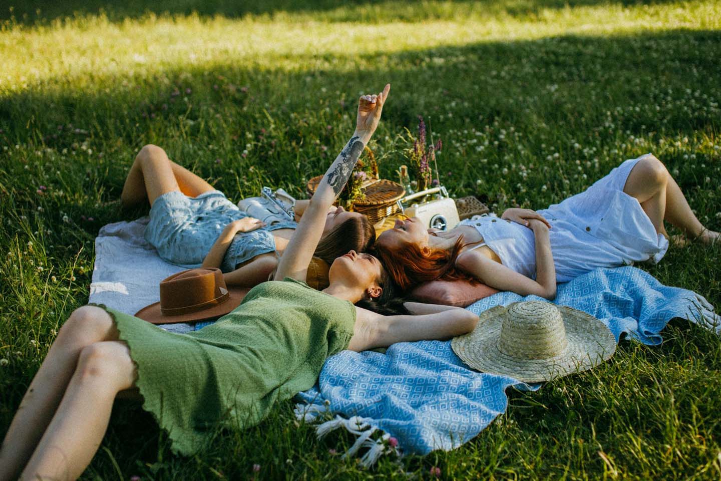 group of friends lying on a picnic blanket