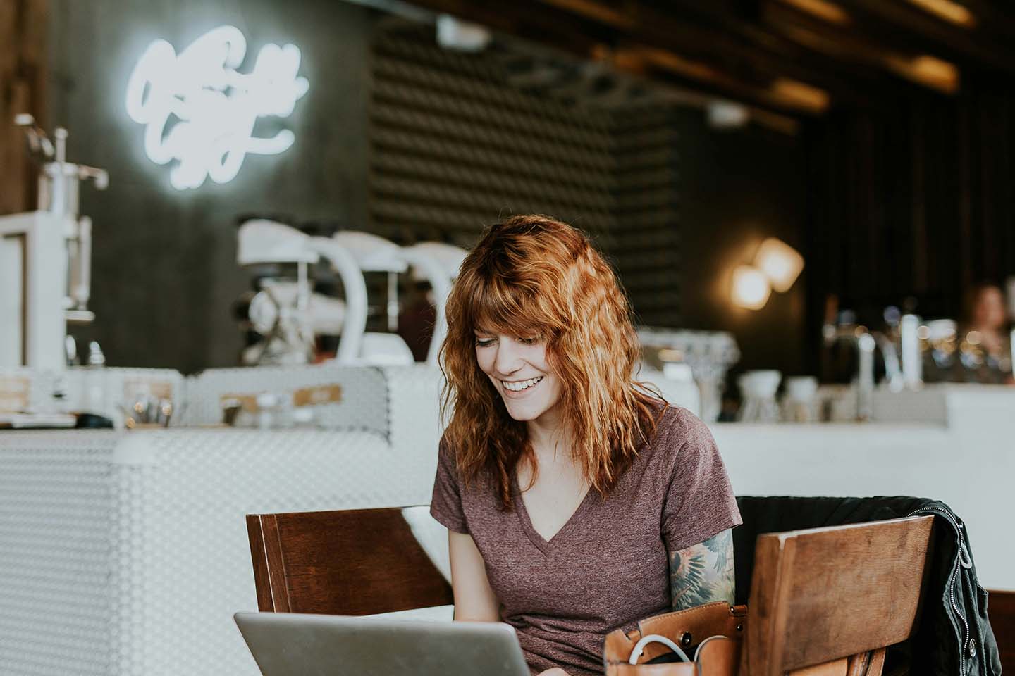 Woman looking at a laptop and smiling