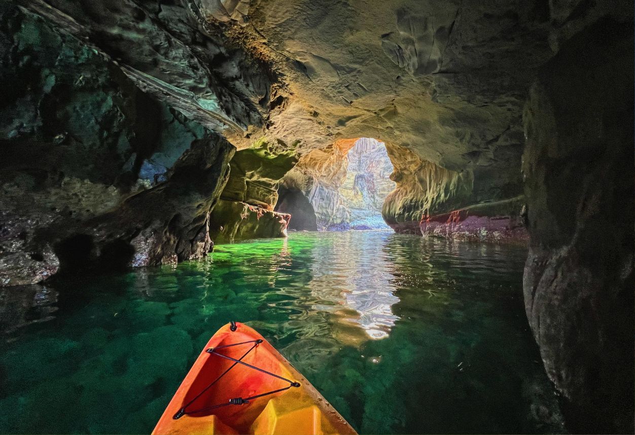 Kayak naranja en la parte trasera de la cueva marina de La Jolla llamada The Clam. Día súper tranquilo y agua clara.