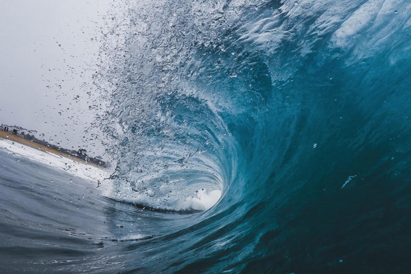 Photo from inside of a wave as it breaks in the ocean.