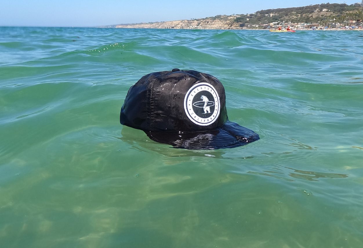Floating waterproof snapback on the water from everyday California