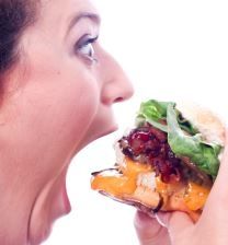 Woman taking big bite