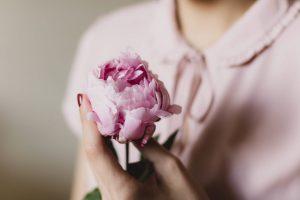 Breast Cancer - image of woman holding flower