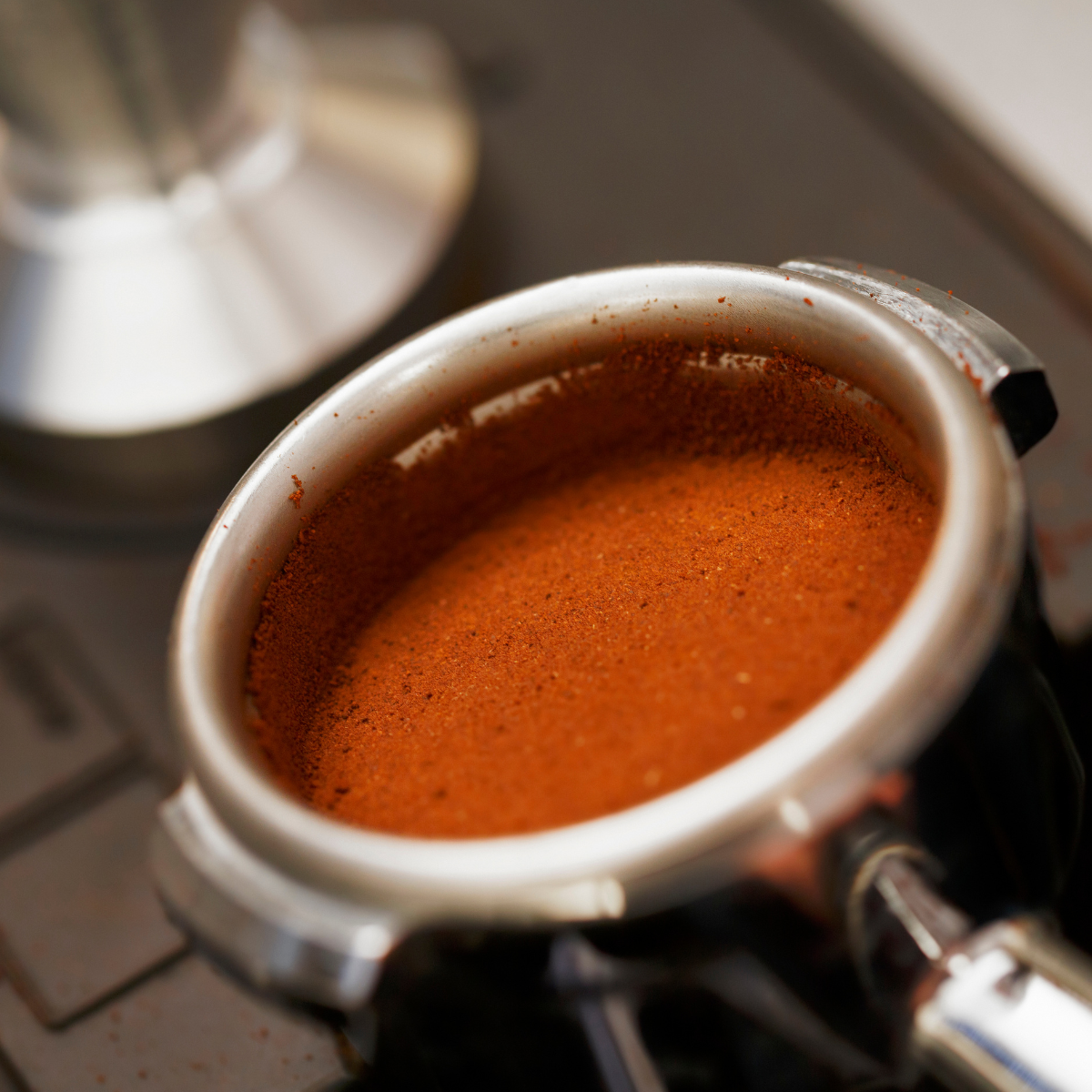 Tamping coffee for espresso: We want those coffee grounds to be compressed uniformly.