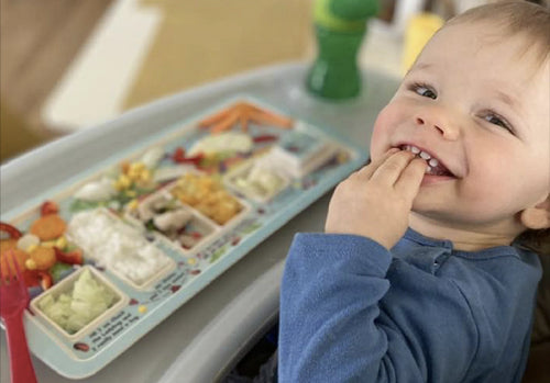 Happy child eating veggies