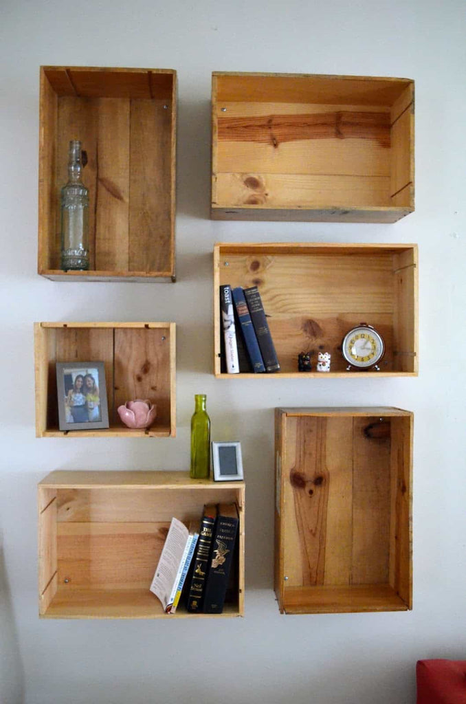 wooden gift boxes turned into shelves on wall