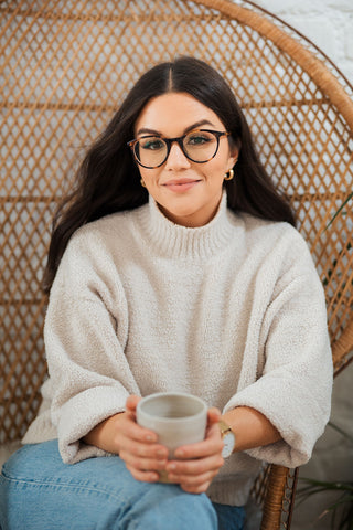 female ceo sat on chair with mug gifting company