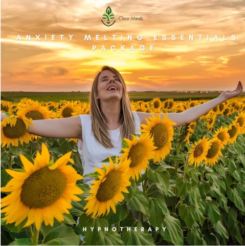 Woman with arms open in field of sunflowers with link to Anxiety Melting Essentials Package