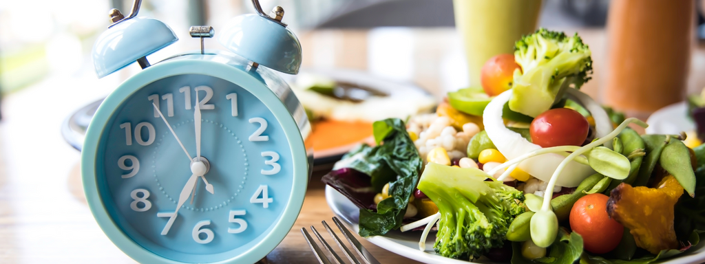 clock and plate of salad