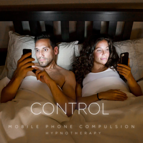 A couple lying in bed looking at their phones