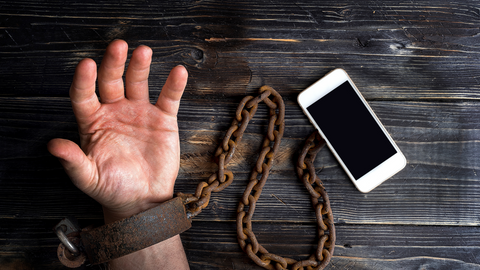 Hand chained to a smart phone