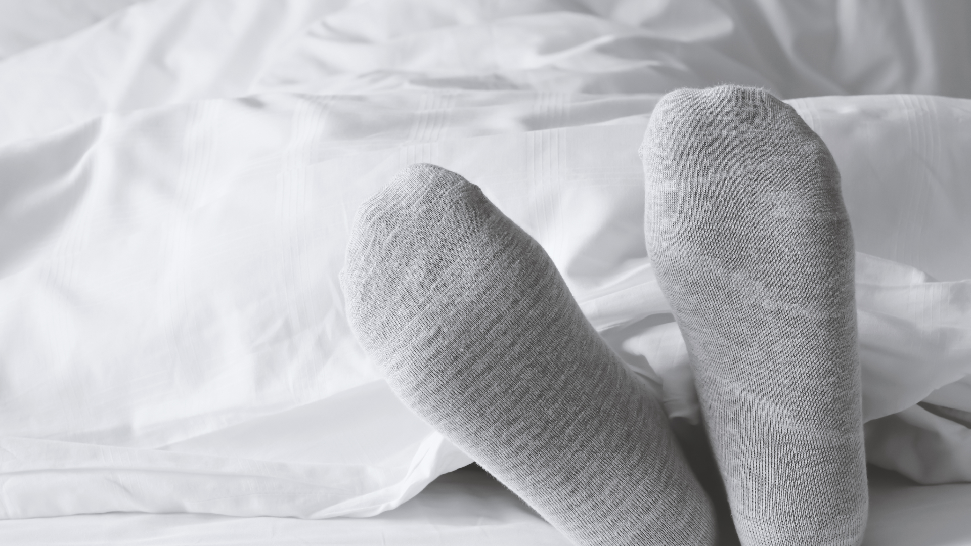 wearing socks in bedsheet