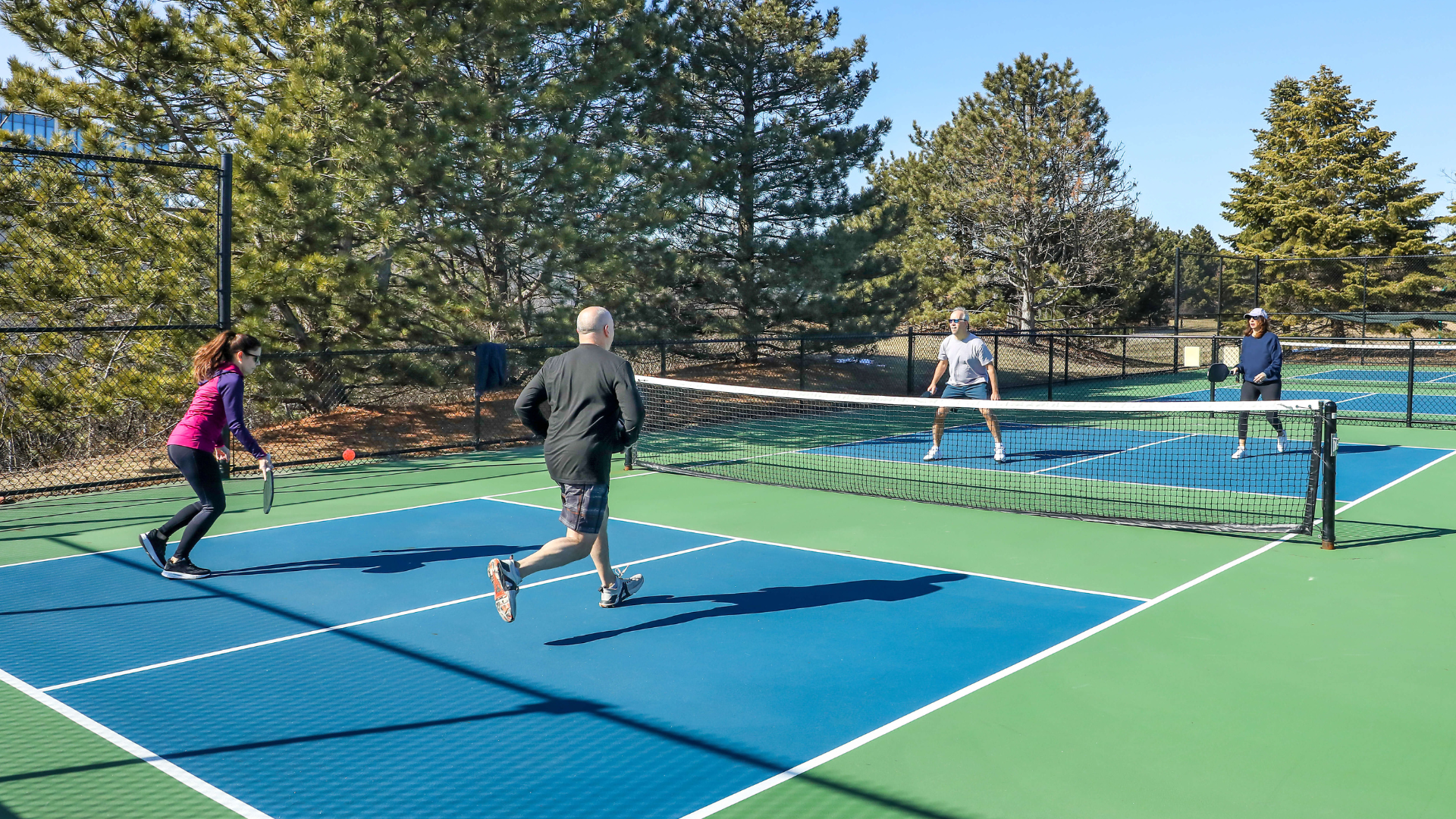 four-players-playing-pickleball