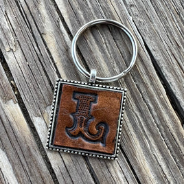https://cdn.shopify.com/s/files/1/0524/9309/1008/products/initial-L-leather-keychain_1_268x.jpg?v=1658946649