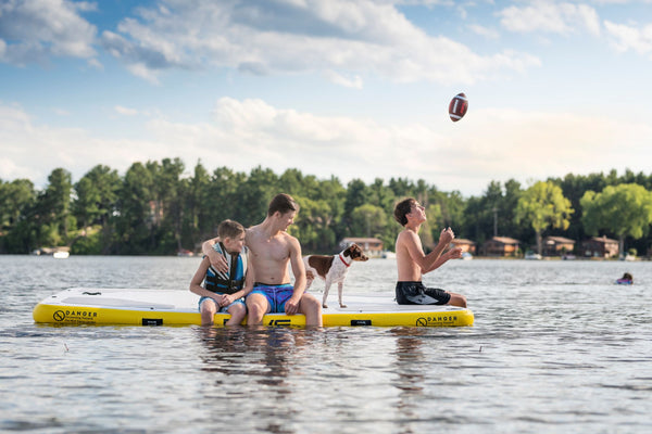 Boys spending time on RAVE Sports Aqua Dock foating mat