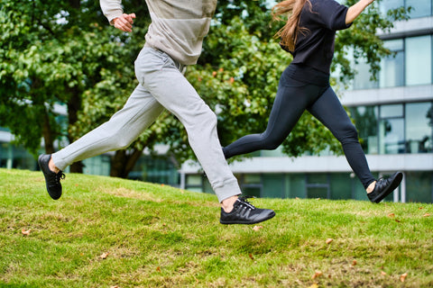 a man and woman running in Ahinsa barefoot shoes