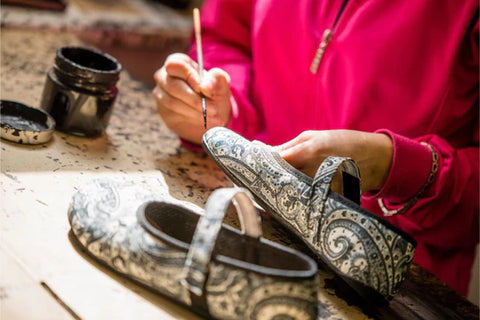 A woman working on producing Ahinsa barefoot ballet flats