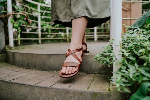 A woman in Ahinsa barefoot sandals walking up stairs