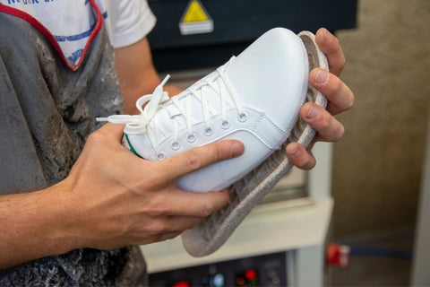 Our colleague attaching the sole to the upper material of the shoe.