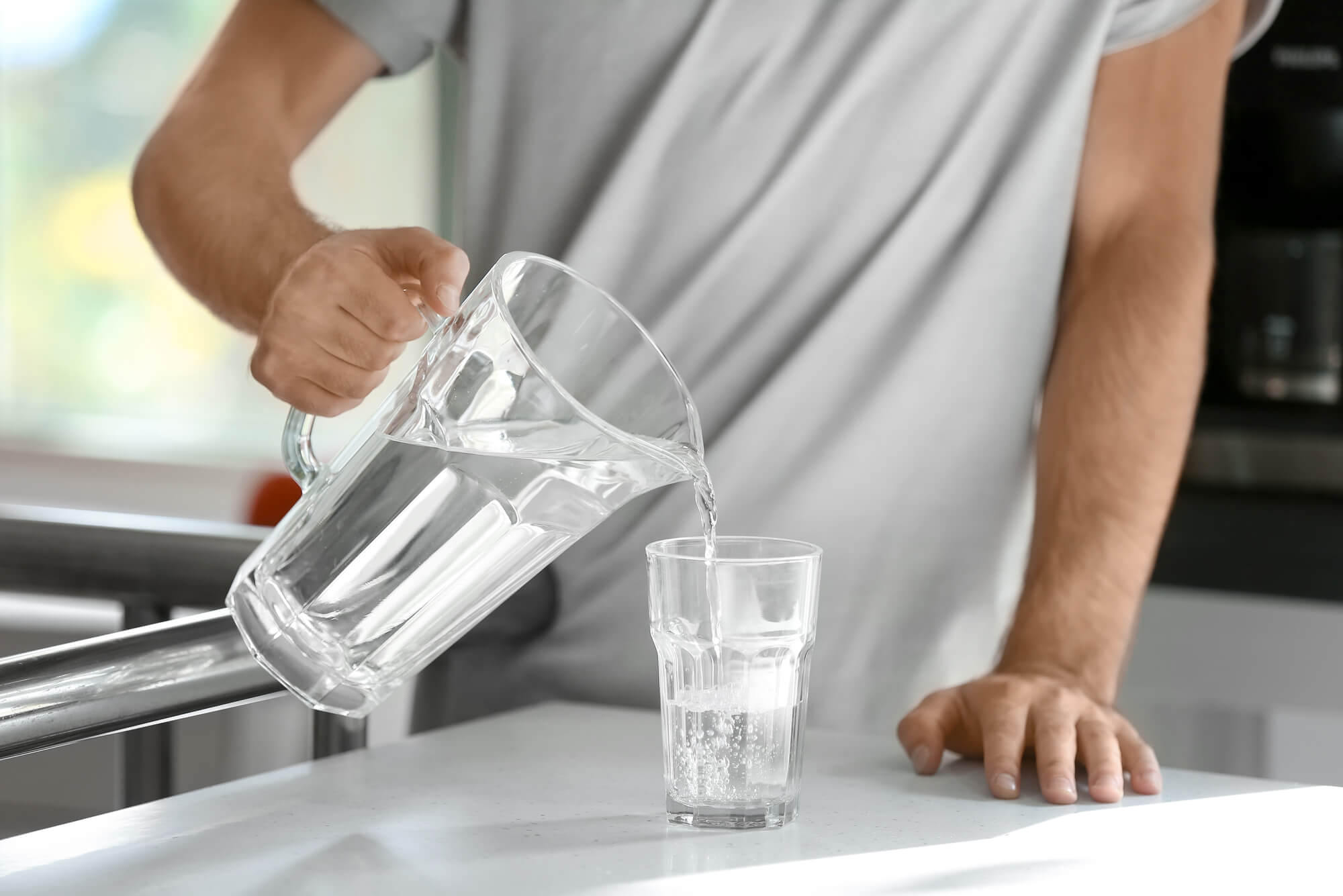 Drinking water from a plastic bottle.