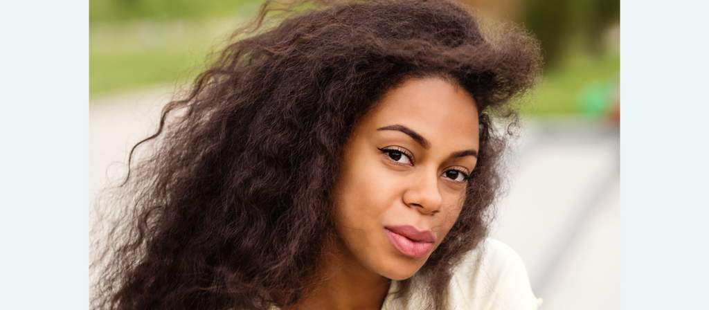 black woman with flat ironed natural hair and heat damage