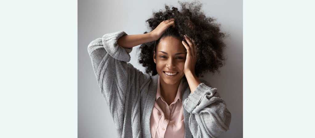 black woman finger detangles matted hair