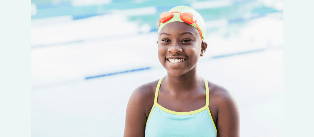 black girls in pool with swim cap to protect hair