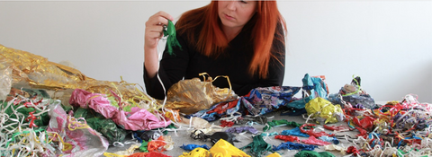 Carly Wilson looking through a table of balloon fragments