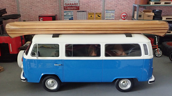 A scale model VW bus with a wooden canoe on top of it