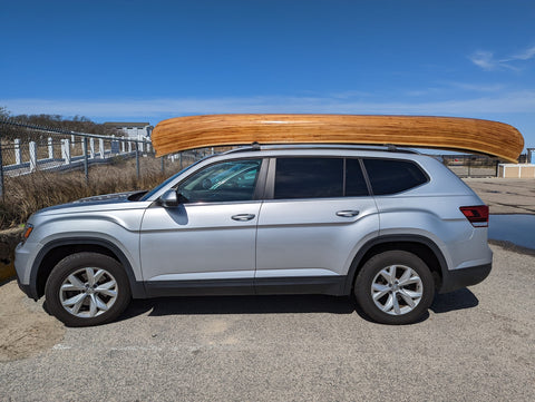 Wooden canoe on the roof of an SUV